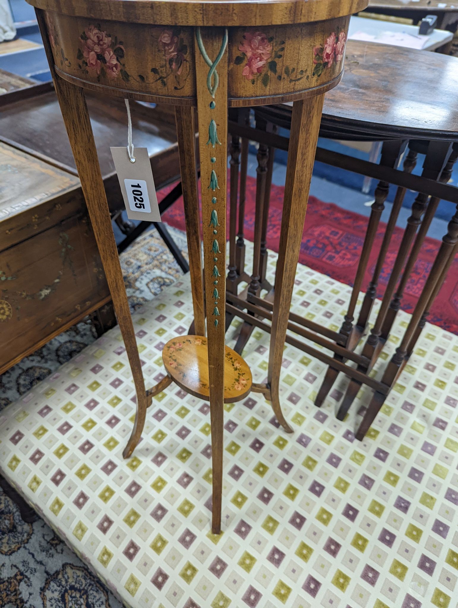 A small Sheraton style oval painted satinwood two tier plant stand, width 30cm, depth 25cm, height 73cm